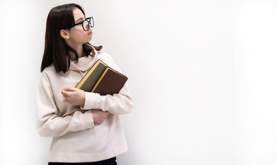 Teenage girl and books. Girl nerd in glasses on a white background. Cognitive literature. A successful intellectual child. Education concept.