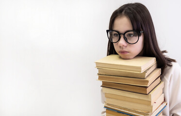 Teenage girl and books. Girl nerd in glasses on a white background. Cognitive literature. A successful intellectual child. Education concept.