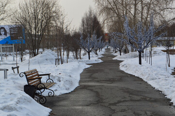 bench in the snow in April 
