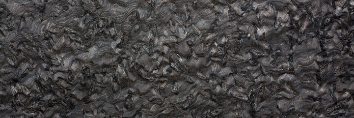Black granite texture on macro. Long slab pattern for your interior design or web site.