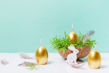 Happy Easter background, spring-time concept. Golden eggs, nests and bunny toys on blue