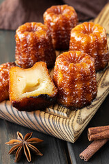 Local French dessert canele on a wooden board
