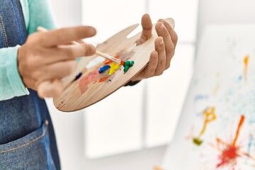 Young redhead man drawing at art studio