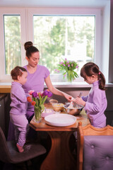 Happy loving family preparing bakery together in the kitchen. 