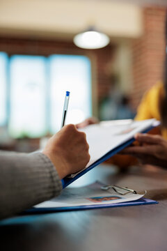 Close up of woman signing papers for executive manager job discussing partnership with businesswoman during company interview. Businesswomen working at business collboration in startup office.