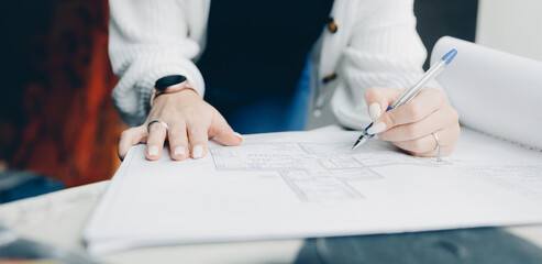 Women foreman architect check work of construction worker with drawing print apartment banner