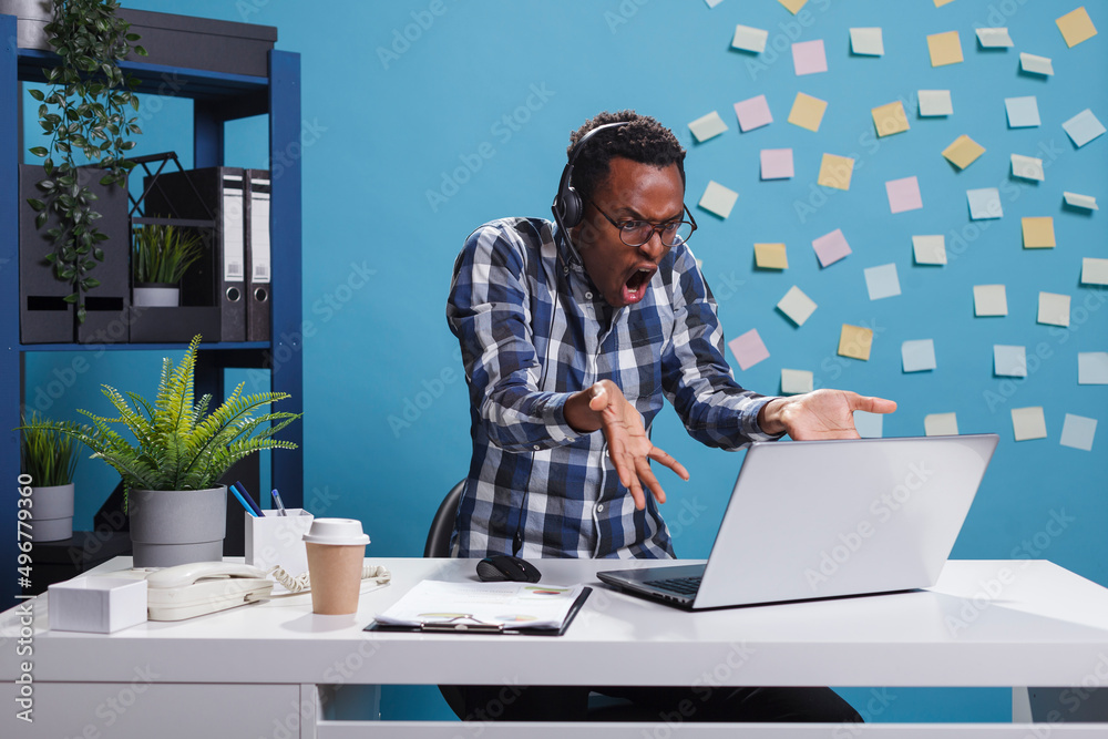 Wall mural furious and annoyed helpdesk representative gesturing aggresively while in call with customer having