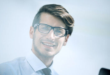 close up.successful young businessman sitting at his Desk