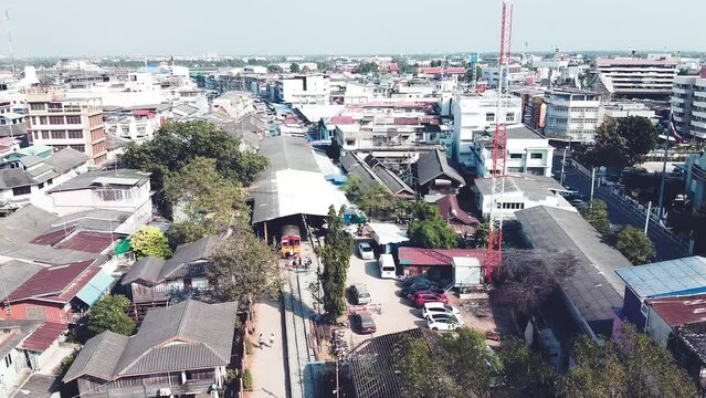 MAEKLONG, THAILAND - DECEMBER 15, 2019: Amazing aerial view of Maeklong cityscape with river and railway market