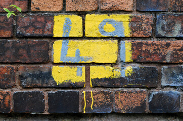 Weathered Number '49' Painted on Old Brick Wall in Close Up 