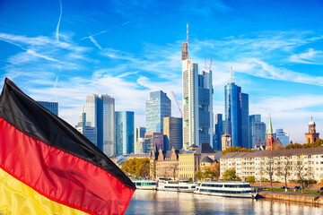 Skyline cityscape of Frankfurt, Germany during sunny day with german flag. Frankfurt Main in a...