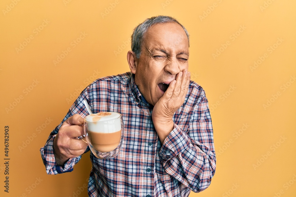 Sticker Handsome senior man with grey hair drinking a cup coffee laughing and embarrassed giggle covering mouth with hands, gossip and scandal concept