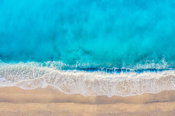 Fototapeta na wymiar Top view aerial drone photo of Myrtos beach with beautiful turquoise water and sea waves. Vacation travel background. Ionian sea, Kefalonia Island, Greece