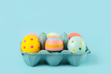 Happy Easter. Easter painted eggs in an open blue cardboard box