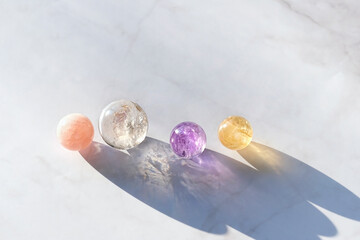 quartz crystals balls on abstract marble background. Magic Witchcraft Ritual, healing crystal practice for positive spirit, harmony, calming, productive the mind. Feng Shui, reiki therapy.
