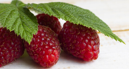 image of raspberries with leaves on a white background