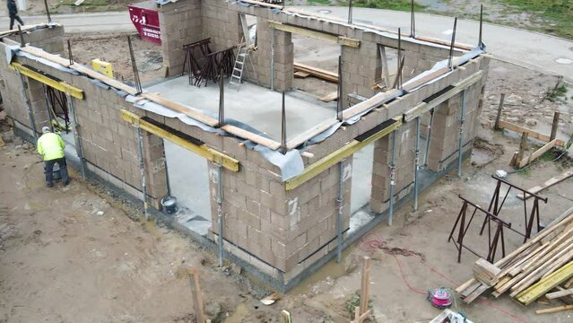 Aerial close rotating view of a hempcrete construction site with prefab blocks