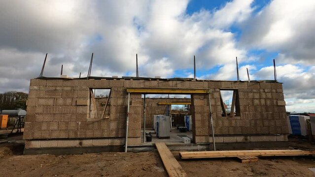 Timelapse of a still hempcrete construction site with moving clouds