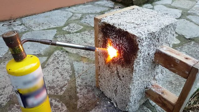Close up of a hempcrete block being flamed by a gas burner