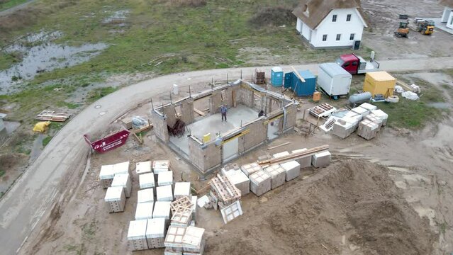 Aerial far rotating view of a hempcrete construction site with prefab blocks