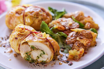 Delicious stuffed chicken on plate with herbs