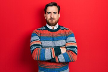 Handsome caucasian man with beard with arms crossed gesture skeptic and nervous, frowning upset because of problem. negative person.