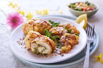 Tasty filled chicken thighs on plate with greenery