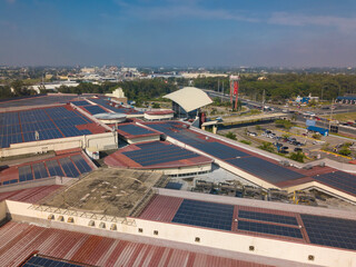 San Fernando, Pampanga, Philippines - Aerial of Robinsons Starmills. A large solar array installed on the mall's roofdeck. - obrazy, fototapety, plakaty