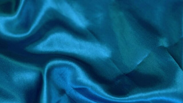 Smooth Shiny Texture Blue Polyester Fabric, Faux Silk, Close-up, Macro. Petroleum Material, Polyester Textile. Backdrop of Shiny Blue Polyester fabric.