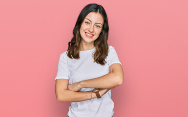 Fototapeta premium Young beautiful woman wearing casual white t shirt happy face smiling with crossed arms looking at the camera. positive person.