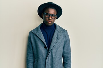Young african american man wearing elegant style skeptic and nervous, frowning upset because of...