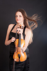 girl in a black dress with a violin