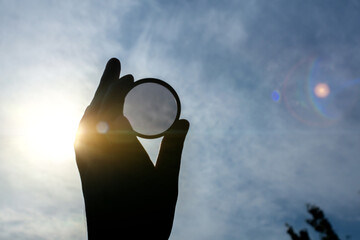 Polarizing filter on a blue sky background. Optics tool for lens in photography