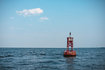 Large buoy in the seawater under the clear blue sky