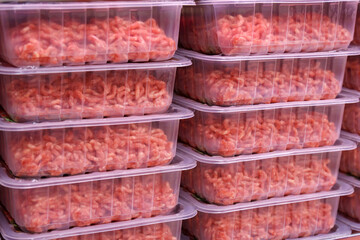 Minced meat in plastic packages on supermarket shelves. Selective focus