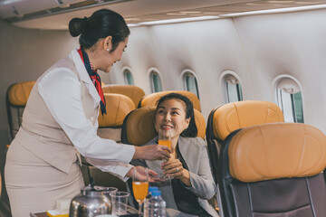 Air hostess flight cabin crew serve food and drink service passenger during travel on board.