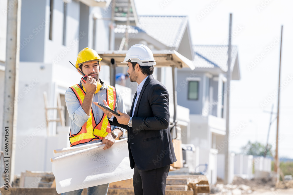 Fototapete architect and developer with blueprints discussing architect project at construction site,constructi