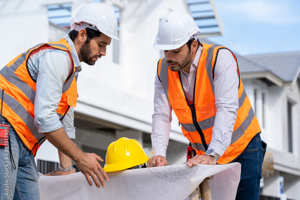 Poster engineer and technician team working and discussing in new home construction site,construction engin