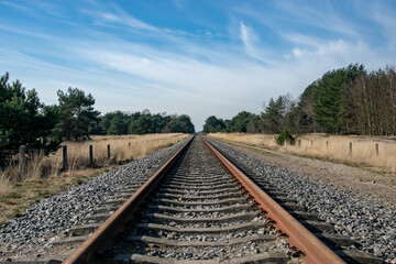 railway in the countryside wit blue sky and clouds