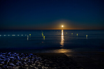 palombaggia beach at night wtih the sea and the moon