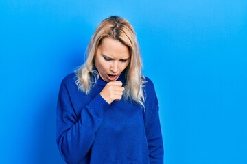 Beautiful caucasian blonde woman wearing turtleneck sweater feeling unwell and coughing as symptom for cold or bronchitis. health care concept.