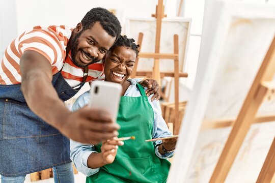 African american painter couple smiling happy making selfie by the smartphone at art studio.