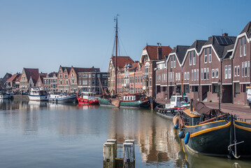 Fototapeta na wymiar Hoorn, Netherlands, March 2022. The harbor of Hoorn with the old boats and historic facades.