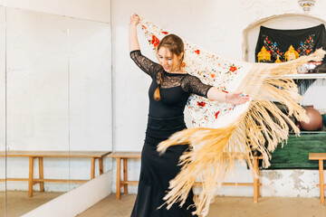 Happy flamenco woman dancer moving the manila shawl