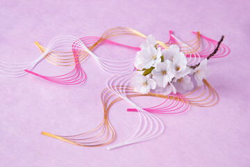 日本の正月イメージ　桜の花束と波型水引のデザイン（ピンクバック）