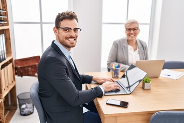 Mother and son business workers using laptop working at office