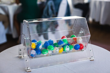 Process of prize drawings, extracting a winning numbers of lottery machine, raffle drum with bingo balls and winning tickets on event with a host and hands on lottery machine
