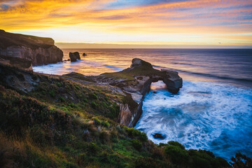 Beautiful shot of Tunnel Beach, Dunedin, New Zealand at sunset