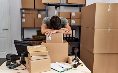 Young hispanic man business worker stressed working at storehouse - obrazy, fototapety, plakaty
