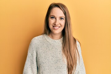 Young blonde woman wearing casual winter sweater with a happy and cool smile on face. lucky person.